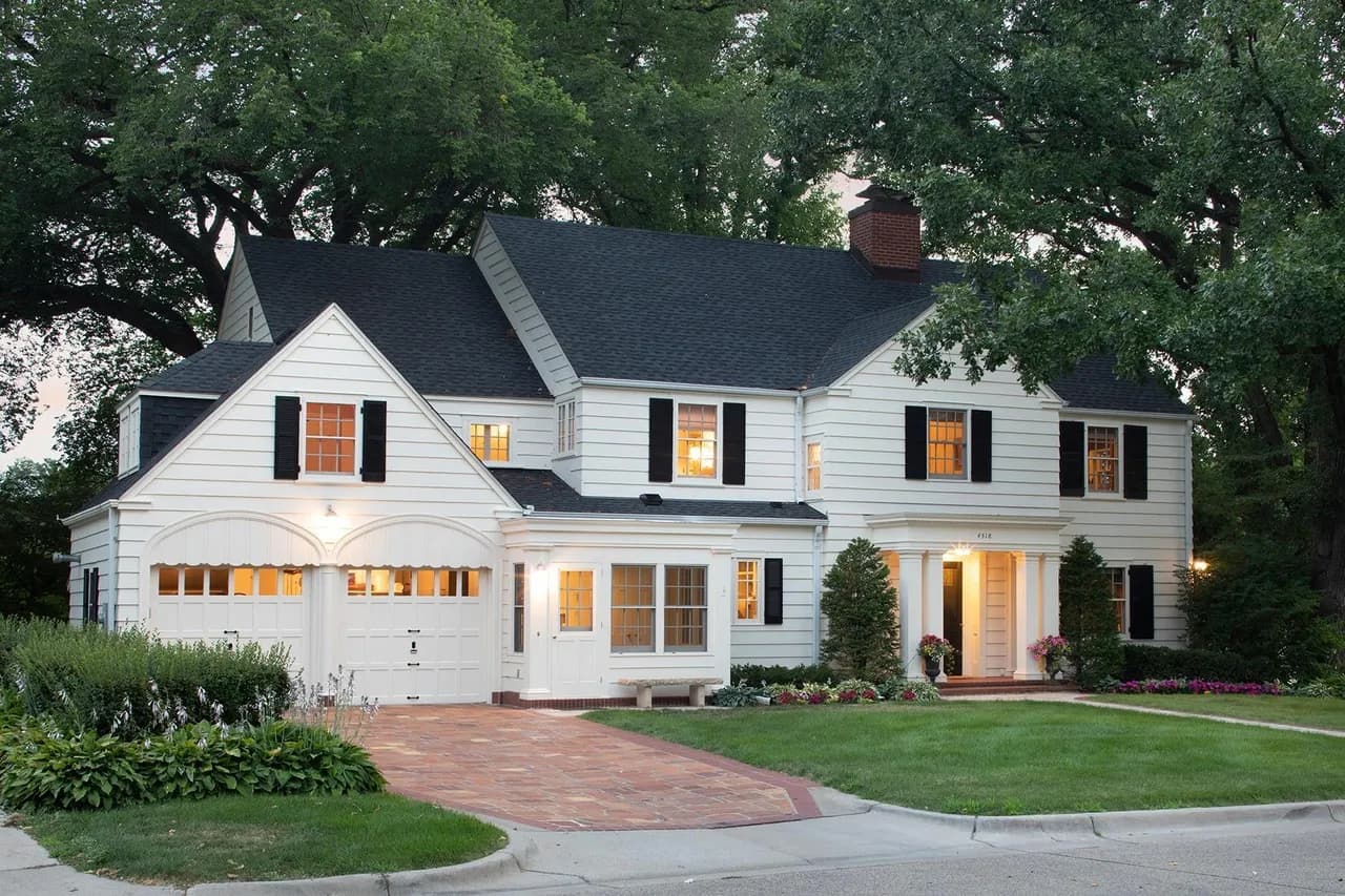 Single-family home exterior with gray siding and landscaped front yard